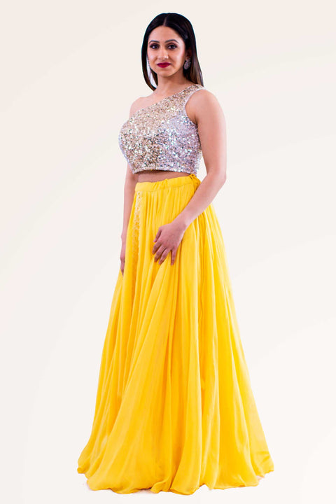 Radiant yellow skirt with slight pleating in the center. Silver glittery one shoulder blouse.