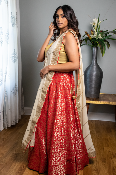 This stunning red lehenga set comes with a beautifully crafted white dupatta.  The set is made of high-quality fabric that drapes gracefully and feels comfortable to wear. It's perfect for weddings, festivals, or any special occasion where you want to look elegant and regal. The white dupatta adds an ethereal touch to the ensemble and completes the look with a touch of sophistication. 
