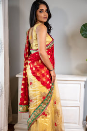 Full of Grace  Gold sari with red border and detailed flower design.   Note: Sari comes with a petticoat, blouse, and jewelry. If you prefer blouse with sleeves please specify in your order.