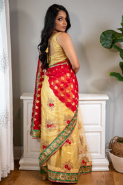 Full of Grace  Gold sari with red border and detailed flower design.   Note: Sari comes with a petticoat, blouse, and jewelry. If you prefer blouse with sleeves please specify in your order.