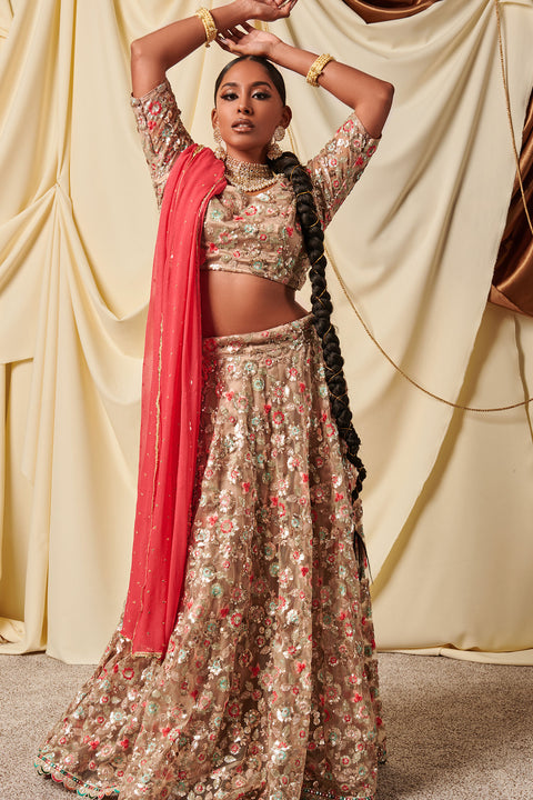 Excellence of Virtue  Beige/Gold net lehenga with intricate flower work on lehenga and blouse.  Comes with a contrast dupatta.   Skirt Length: 42 inches (Can not be altered)  Note: Blouse style and complimentary jewelry may vary depending on size and availability.