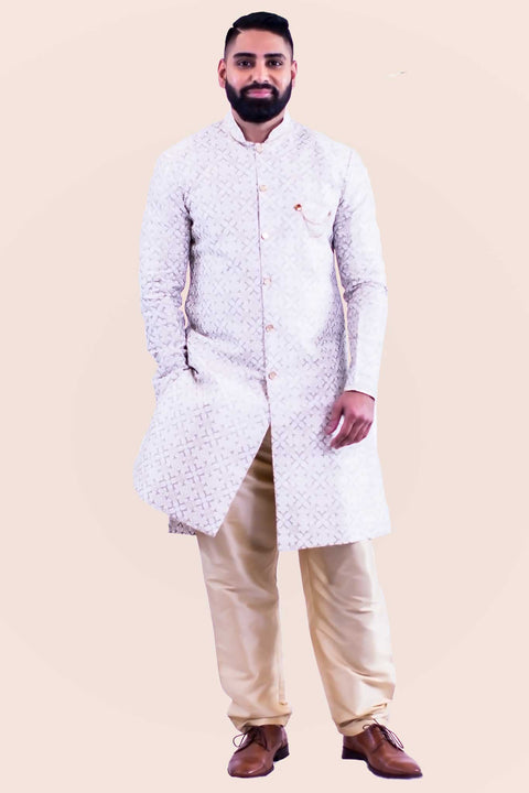 Kurta style sherwani, silk blend with a with gold buttons from collar to mid torso. This kurta is paired with a neutral color pants.
