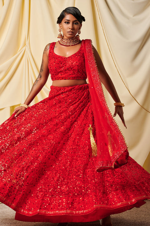 Burn fiercely  Red net lehenga with intricate flower work on lehenga and blouse.  Comes with matching dupatta.   Skirt Length: 42 inches (Can not be altered)  Note: Blouse style and complimentary jewelry may vary depending on size and availability.