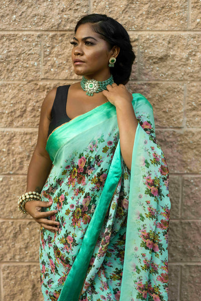 You run the day  Lightweight emerald silk sari with flower print  Note: Sari comes with a petticoat and blouse. Blouse style and jewelry style may change depending on availability.