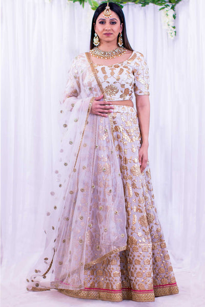 Beautiful blouse with gold embroidery, paired with matching skirt and pink trim, providing an always classic look.