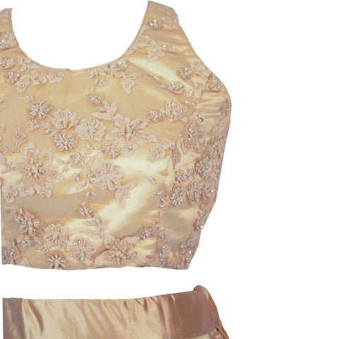 Elegant two piece silk champagne lehenga. Side slit on skirt for edgy look, paired with flower beading work on blouse