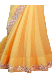 Gorgeous yellow chiffon sari covered in gold specks with champagne color hand work through out the border of the saree. This type of traditional craftsmanship is called gotta patti.