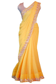 Gorgeous yellow chiffon sari covered in gold specks with champagne color hand work through out the border of the saree. This type of traditional craftsmanship is called gotta patti.