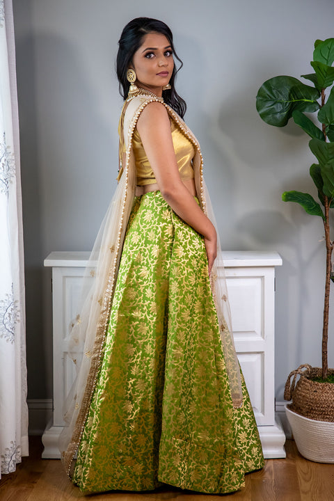 Mojitos and me, mint to be  Green and gold lehenga with gold printed work, paired with gold dupatta and blouse.   Skirt Length: 40 (Can not be altered)  Note: Blouse style and complimentary jewelry may vary depending on size and availability.