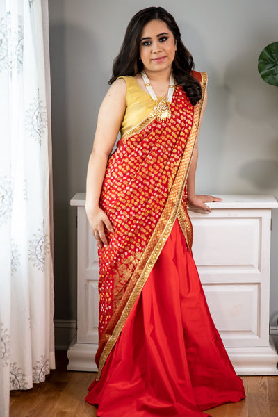 Dressed to Kill  Red lehenga with bandhani dupatta and gold blouse.    Skirt Length: 40 inches (Can not be altered)   Note: Blouse style and complimentary jewelry may vary depending on availability.  