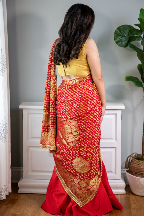 Dressed to Kill  Red lehenga with bandhani dupatta and gold blouse.    Skirt Length: 40 inches (Can not be altered)   Note: Blouse style and complimentary jewelry may vary depending on availability.  